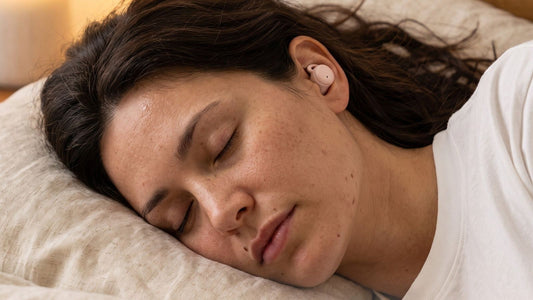 Woman asleep on her side wearing a ViSound Hush sleep earbud